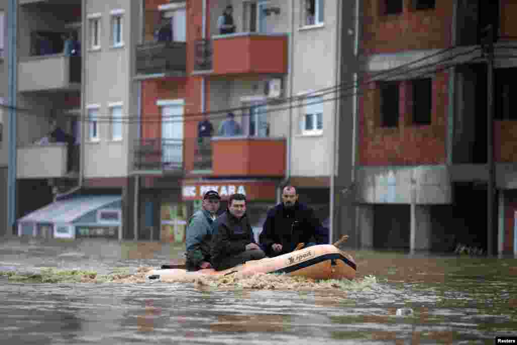 A rescue team looks for residents in need of help evacuating the town of Obrenovac, Serbia.