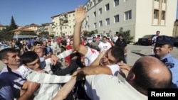 Supporters of the ruling United National Movement scuffle with supporters of the opposition Georgian Dream coalition during an election rally last week in the town of Signagi. Can the opposition consolidate a peaceful transition, and will the ruling party let them?