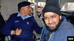 Mumtaz Qadri (right) after his arrest in 2011