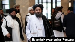 FILE: Members of a Taliban delegation, led by chief negotiator Mullah Abdul Ghani Baradar (C, front), walk before a meeting with Afghan senior politicians in Moscow in May.