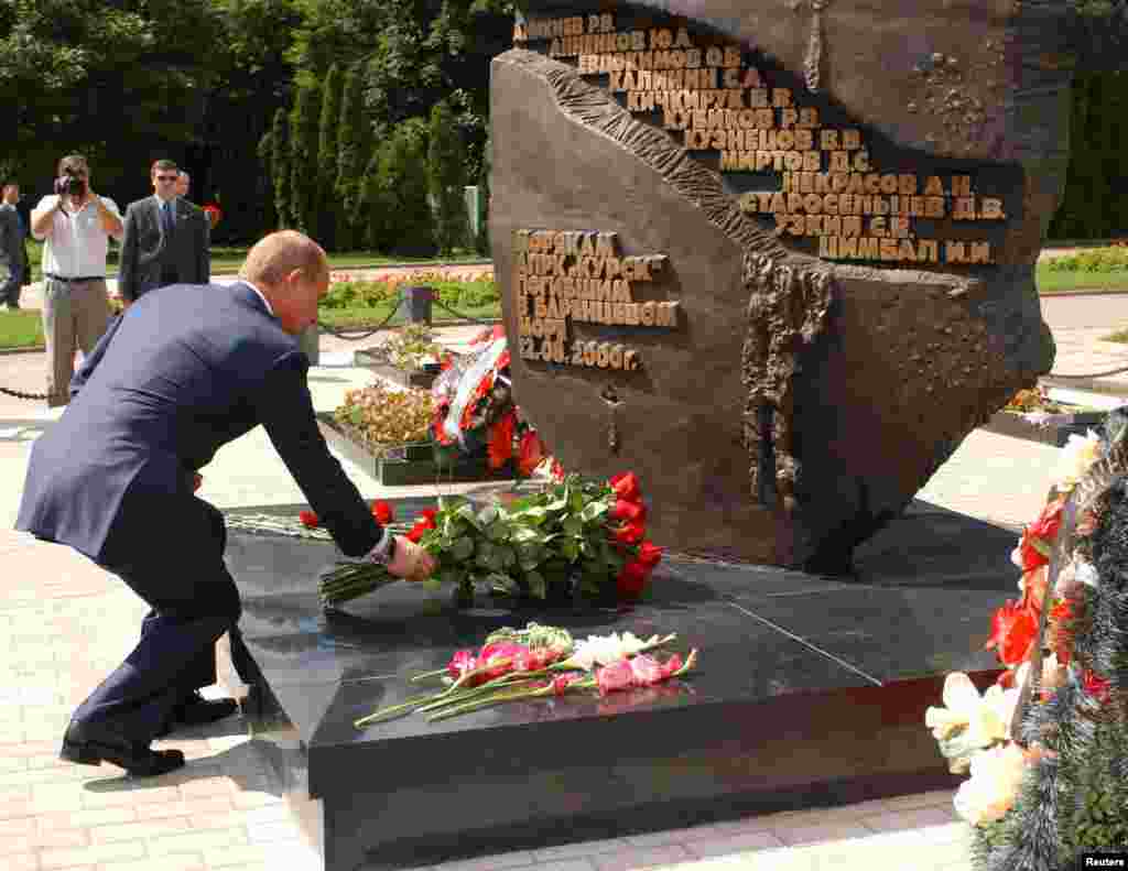 Russian President Vladimir Putin lays flowers at the monument to the 118 sailors who died aboard the "Kursk" nuclear submarine during a visit to Kursk in August 2003.