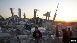 Palestinian boys play where a house once stood in east Gaza City.