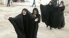 Women mourn during a funeral for a victim who was killed in one of the December 22 bomb attacks.