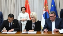 Serbian Construction Minister Zorana Mihajlovic (center) signs a contract with a Chinese company to build new stretch of road in western Serbia.