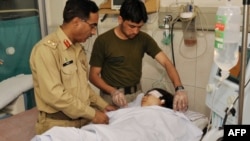 Pakistani doctors treat Malala Yousafzai at an army hospital following an attack by gunmen in Peshawar.