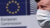 Muškarac sa maskom prolazi ispred sedišta Evropske komisije 