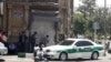 Journalists and a police vehicle at the scene outside Iranian parliament in the capital Tehran during an attack on the complex, 07Jun2017