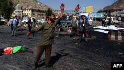 An Afghan man gesticulates near the scene of a deadly suicide attack that targeted crowds of minority Shi'ite Hazaras during a demonstration in Kabul on July 23.