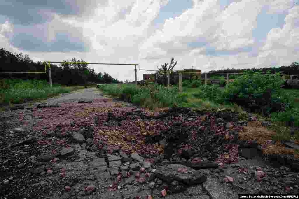 A large crater from heavy artillery that struck 10 days earlier near a checkpoint