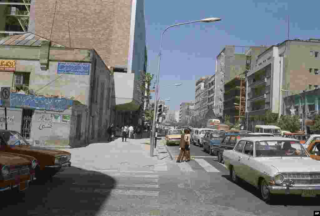 A street scene showing pedestrians threading their way between bumper-to-bumper traffic, June 16, 1970, Tehran, Iran. (AP Photo/Roy Essoyan)