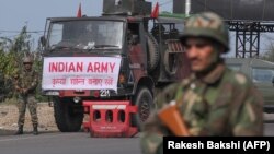 An Indian Army soldier stands guard during a curfew in Jammu.