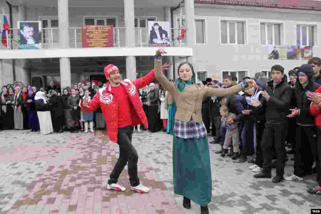 A young man and woman dance outside a polling station in Grozny during Russia's presidential election in March 2012.