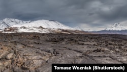 A lava flow from Kamchatka's Tobalchik Volcano, which last erupted in 1975, with the newly active Bolshaya Udina Volcano (right).