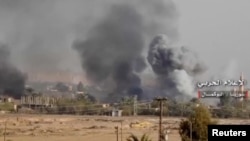 Smoke rises in Albu Kamal, Syria in this still image taken from a video, November 19, 2017. FILE PHOTO
