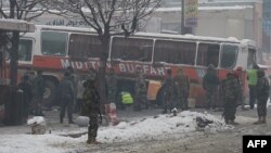 Afghan National Army soldiers investigate the scene following a suicide attack targeting a bus carrying Afghan army personnel in Kabul on February 27.