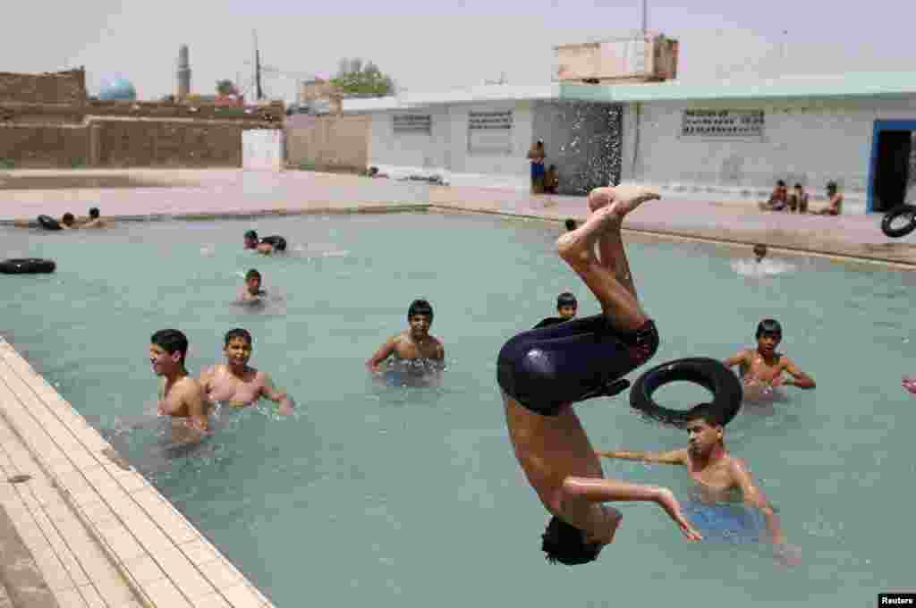 Youths play at a swimming pool in Sadr City.