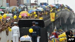 More than 100,000 people came out to pay respects as the coffin of ex-President Corazon Aquino passed through the rain-soaked streets of Manila on August 5.