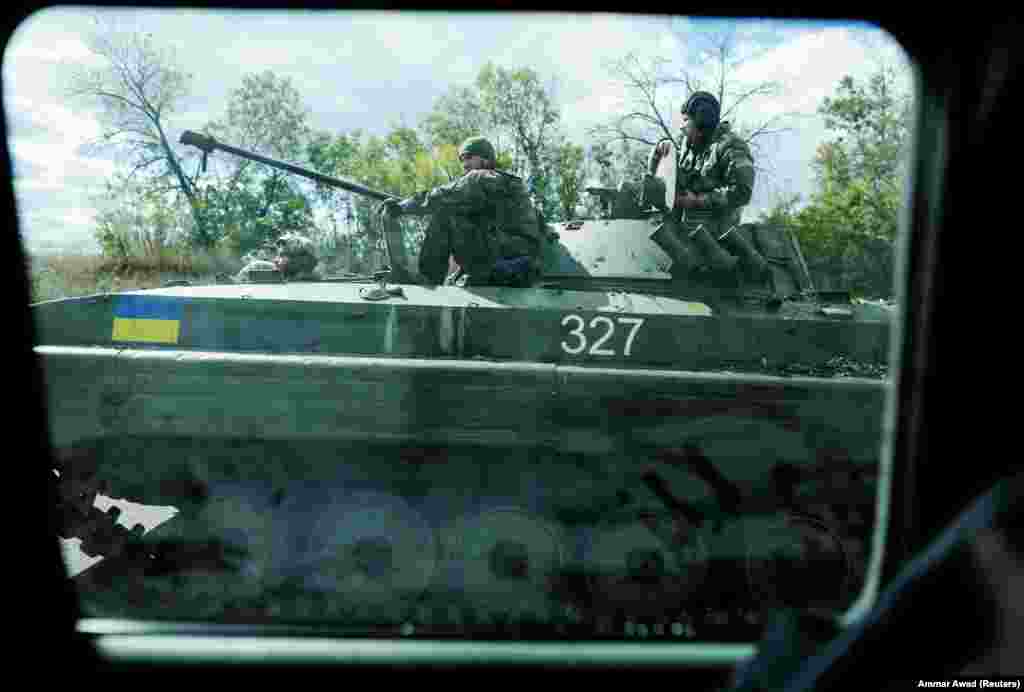 Ukrainian soldiers riding a BTR amphibious armoured personnel carrier drive out of Bakhmut in Ukraine&#39;s Donetsk region.
