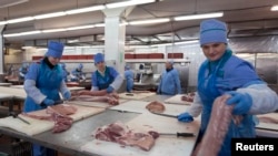 Belarusian workers prepare meat at a processing plant in Brest. 