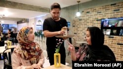 Two Afghan citizens spend time at an Afghan-owned cafe in downtown Tehran, October 7, 2019