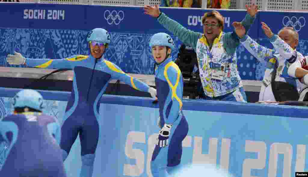 Kazakh skaters Denis Nikisha and Nurbergen Zhumagaziev (left) after the men's 5,000 meters short track speed skating relay semi-final in the Iceberg Skating Palace. 