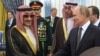 Russian President Vladimir Putin shaking hands with Saudi Prince Walid bin Talal bin Abdulaziz Al Saud (L) in Riyadh, Saudi Arabia, on October 14, 2019. (Photo by Bandar AL-JALOUD / Saudi Royal Palace / AFP) 