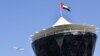 An Etihad Airways plane flies over the main control tower at the Yas Marina circuit ahead of the start of the Abu Dhabi Formula One Grand Prix on November 27, 2016. / AFP PHOTO / Andrej ISAKOVIC