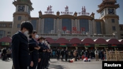 Залізничники на Центральному вокзалі Пекіну вшановують хвилину мовчання, 4 квітня 2020 року