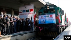 Iran -- Iranian officials applaud on the platform as the first train connecting China and Iran arrives at Tehran Railway Station, February 15, 2016