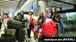 Armenia -- A Syrian Armenian family from Aleppo arrives at Yerevan airport, 25Oct2016.