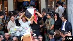 Christians carry coffins of their slain relatives during a funeral service at a church in Baghdad on November 2 for victims of the attack at the Assyrian Catholic Church of Our Lady of Salvation on the evening of October 31.