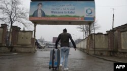 An Afghan refugee who was deported from Germany arrives with his belongings at the international airport in Kabul in January 2017.