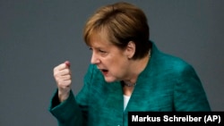 German Chancellor Angela Merkel delivers a speech during a debate at the German parliament in Berlin on June 28.