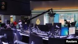 Staff work inside the headquarters of Al Jazeera Media Network, in Doha, June 8, 2017