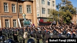 Riot police confront protesters in the Iranian city of Urmia on November 16. 