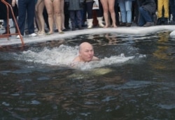 Luzhkov (seen here swimming in an icy lake) was notable for quixotic initiatives, such as a campaign against foreign words in advertising and his seeding of the clouds to prevent rainfall during major outdoor events.