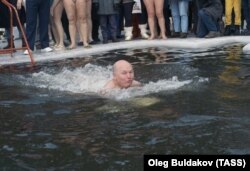 Luzhkov (seen here swimming in an icy lake) was notable for quixotic initiatives, such as a campaign against foreign words in advertising and his seeding of the clouds to prevent rainfall during major outdoor events.