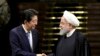 Japanese Prime Minister Shinzo Abe, left, and Iranian President Hassan Rouhani shake hands after their joint press conference on June 12, 2019. 