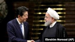 Japanese Prime Minister Shinzo Abe, left, and Iranian President Hassan Rouhani shake hands after their joint press conference at the Saadabad Palace in Tehran, Iran, Wednesday, June 12, 2019. The Japanese leader is in Tehran on an mission to calm tensions between the U.S. and Ira