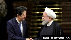 Japanese Prime Minister Shinzo Abe, left, and Iranian President Hassan Rouhani shake hands after their joint press conference at the Saadabad Palace in Tehran, Iran, Wednesday, June 12, 2019. The Japanese leader is in Tehran on an mission to calm tensions between the U.S. and Ira