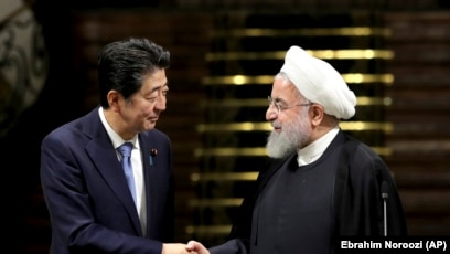 Japanese Prime Minister Shinzo Abe, left, and Iranian President Hassan Rouhani shake hands after their joint press conference at the Saadabad Palace in Tehran, Iran, Wednesday, June 12, 2019. The Japanese leader is in Tehran on an mission to calm tensions between the U.S. and Ira