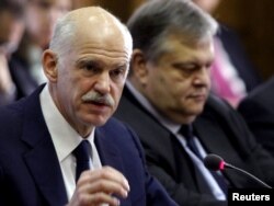 Greek Prime Minister George Papandreou (left) and Finance Minister Evangelos Venizelos in an urgent cabinet meeting in Athens on November 3.