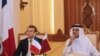 French President Emmanuel Macron (L) and Qatari Emir Sheikh Tamim bin Hamad al-Thani (R) watch as their foreign ministers sign bilateral agreements in the capital Doha, December 7, 2017