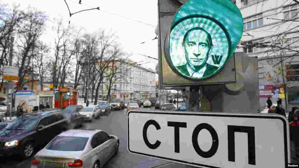 A traffic light displays the image of Russian Prime Minister Vladimir Putin in Moscow on February 10. Images of Putin were stuck onto traffic lights in different parts of the city ahead of the presidential elections scheduled for March 4. The sign reads: &quot;Stop.&quot; (Reuters/Sergei Karpukhin)