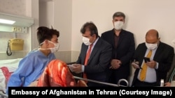 The Afghan ambassador in Iran Abdul Ghafoor Liwal meets the injuried Afghan in Yazd, Iran. June 6, 2020 
