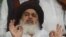 FILE: Khadim Hussain Rizvi, ultra-religious Tehreek-e-Labaik Pakistan (TLP) party, gestures as he speaks to media in Lahore in July.