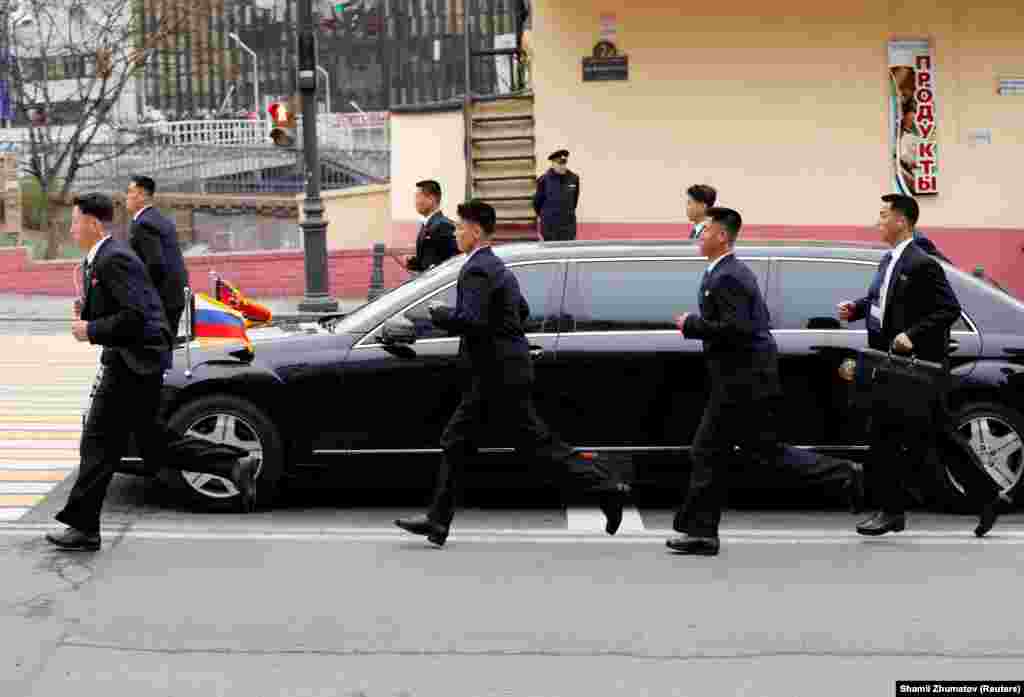Jogging security personnel escort Kim&#39;s vehicle through Vladivostok.&nbsp;