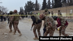 Paramilitary soldiers enter the cordoned site after gunmen shot dead four paramilitary soldiers in Quetta on February 14.