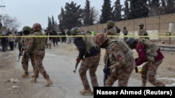 Paramilitary soldiers enter the cordoned site after gunmen shot dead four paramilitary soldiers in Quetta on February 14.