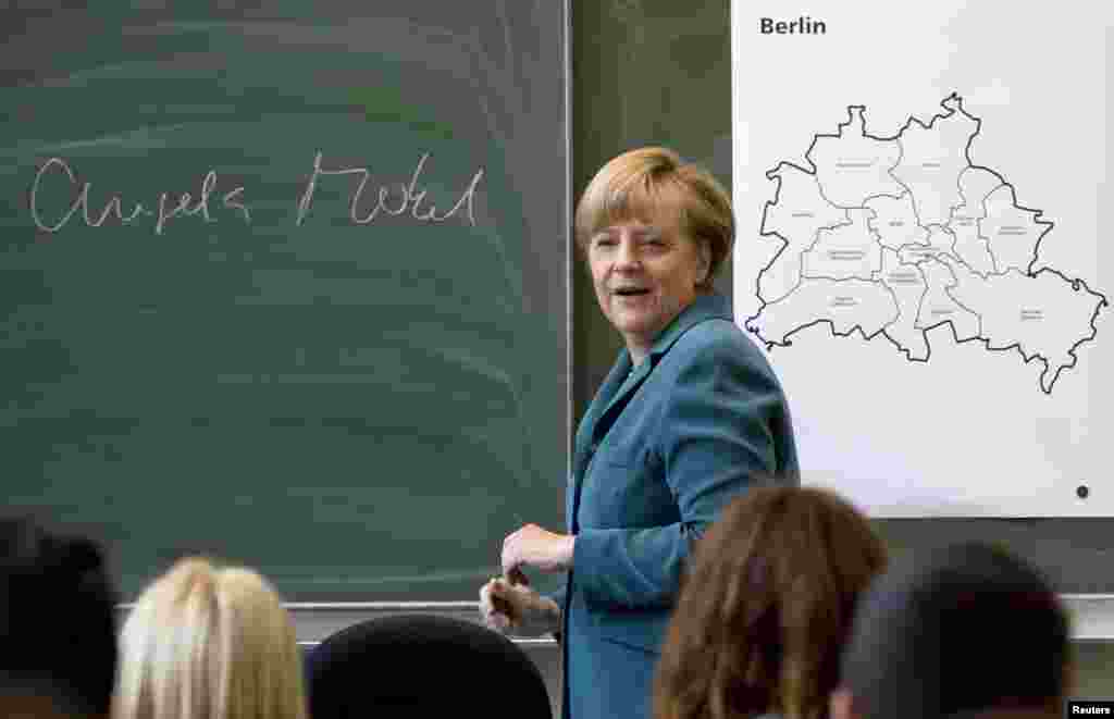 Merkel deliveres a lecture about the Berlin Wall at Heinrich Schliemann Gymnasium, a secondary school in Berlin, in August 2013.